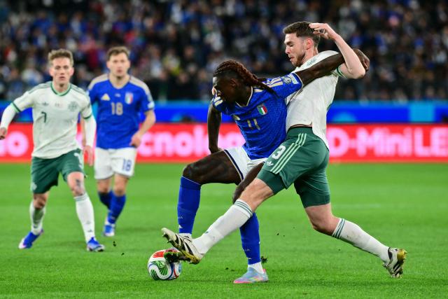 Italy's forward #11 Moise Kean fights for the ball with Northern Ireland's defender  #13 Ruairi McConville during the play-off FIFA World Cup 2026 European qualification semi-final football match between Italy and North Ireland at the Gewiss stadium in Bergamo, on March 26, 2026. (Photo by Stefano RELLANDINI / AFP)
