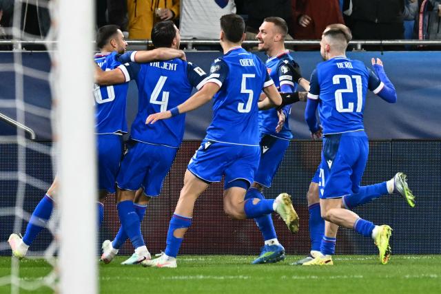 Slovakia's defender #04 Martin Valjent celebrates with teammates scoring his team's first goal during the play-off 2026 FIFA World Cup European qualification semi-final football match between Slovakia and Kosovo in Bratislava on March 26, 2026. (Photo by Joe Klamar / AFP)