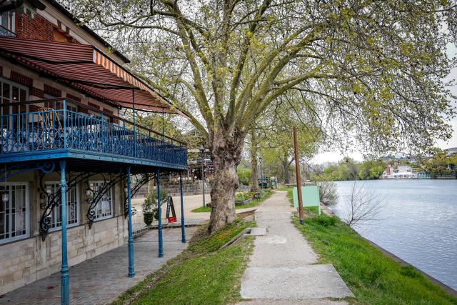 This photograph shows the terrace where French impressionist Pierre-Auguste Renoir (1841-1919) created his painting "Luncheon of the Boating Party" (Le Dejeuner des Canotiers) at the Fournaise Museum on the Ile des Impressionnistes in Chatou, northwest Paris, on March 26, 2026. (Photo by STEPHANE DE SAKUTIN / AFP)