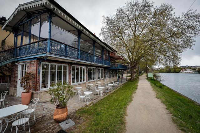 This photograph shows the terrace where French impressionist Pierre-Auguste Renoir (1841-1919) created his painting "Luncheon of the Boating Party" (Le Dejeuner des Canotiers) at the Fournaise Museum on the Ile des Impressionnistes in Chatou, northwest Paris, on March 26, 2026. (Photo by STEPHANE DE SAKUTIN / AFP)