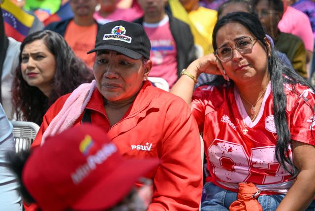 Supporters of Venezuela's ousted president Nicolas Maduro attend a demonstration in Caracas on March 26, 2026, as he appeared in court in New York. Ousted Venezuelan president Nicolas Maduro was back in a New York court on March 26, 2026 for his second appearance since his capture by US forces in an extraordinary nighttime raid. (Photo by Juan BARRETO / AFP)