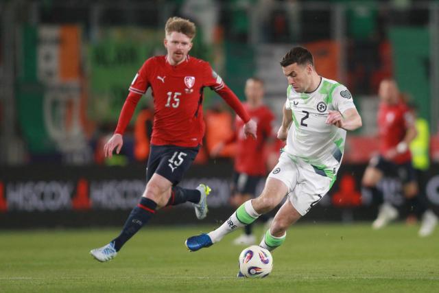 Czech Republic's midfielder #15 Pavel Sulc (L) and Ireland's defender #02 Seamus Coleman vie for the ball during the FIFA World Cup 2026 European qualification semi final football match Czech Republic vs Ireland on March 26, 2026 in Prague. (Photo by MILAN KAMMERMAYER / AFP)