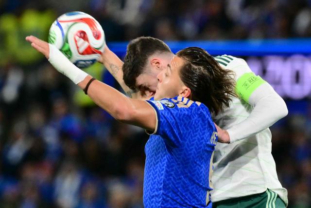 Italy's forward #09 Mateo Retegui (L) fights for the ball with Northern Ireland's defender  #05 Trai Hume during the play-off FIFA World Cup 2026 European qualification semi-final football match between Italy and North Ireland at the Gewiss stadium in Bergamo, on March 26, 2026. (Photo by Stefano RELLANDINI / AFP)