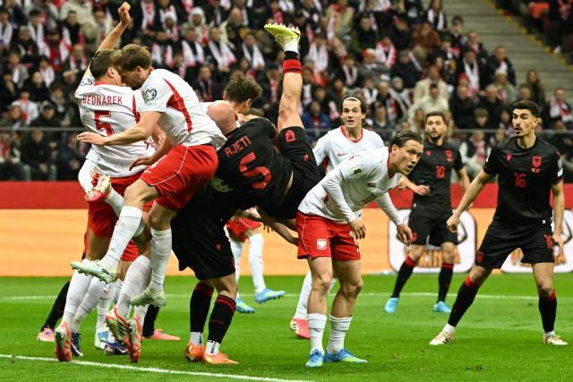 Albania's defender #05 Arlind Ajeti (C) crashes before an injury during the play-off FIFA World Cup 2026 European qualification semi-final football match between Poland and Albania in Warsaw on March 26, 2026. (Photo by Sergei GAPON / AFP)