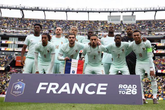 France national team players (from L) #08 Aurelien Tchouameni, #11 Michael Olise, #14 Adrien Rabiot, #19 Theo Hernandez, #22 Hugo Ekitike, #04 Dayot Upamecano, #02 Malo Gusto, #15 Ibrahima Konate, #07 Ousmane Dembele, #16 Mike Maignan and #10 Kylian Mbappe pose ahead of a friendly football match between Brazil and France at Gillette Stadium in Foxborough, Massachusetts, on March 26, 2026. (Photo by FRANCK FIFE / AFP)