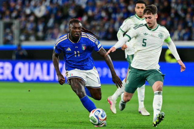 Italy's forward #11 Moise Kean fights for the ball with Northern Ireland's defender  #05 Trai Hume during the play-off FIFA World Cup 2026 European qualification semi-final football match between Italy and North Ireland at the Gewiss stadium in Bergamo, on March 26, 2026. (Photo by Stefano RELLANDINI / AFP)