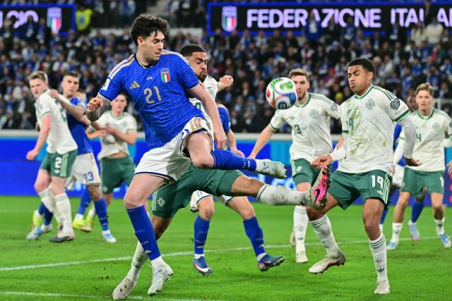 Italy's defender #21 Alessandro Bastoni fights for the ball with Northern Ireland's defender #20 Brodie Spencer during the play-off FIFA World Cup 2026 European qualification semi-final football match between Italy and North Ireland at the Gewiss stadium in Bergamo, on March 26, 2026. (Photo by Stefano RELLANDINI / AFP)
