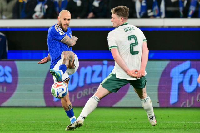 Italy's forward #05 Manuel Locatelli kicks the ball in front of Northern Ireland's midfielder #02 Terry Devlin during the play-off FIFA World Cup 2026 European qualification semi-final football match between Italy and North Ireland at the Gewiss stadium in Bergamo, on March 26, 2026. (Photo by Stefano RELLANDINI / AFP)