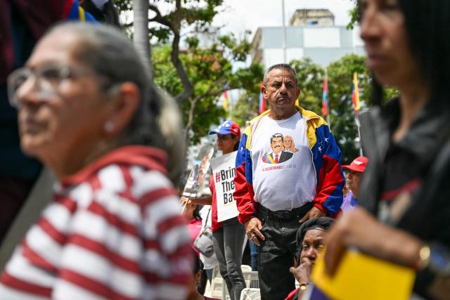 Supporters of Venezuela's ousted president Nicolas Maduro attend a demonstration in Caracas on March 26, 2026, as he appeared in court in New York. Ousted Venezuelan president Nicolas Maduro was back in a New York court on March 26, 2026 for his second appearance since his capture by US forces in an extraordinary nighttime raid. (Photo by Juan BARRETO / AFP)