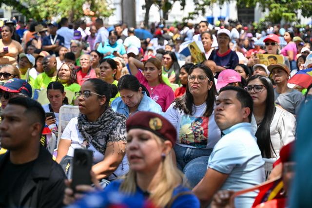 Supporters of Venezuela's ousted president Nicolas Maduro attend a demonstration in Caracas on March 26, 2026, as he appeared in court in New York. Ousted Venezuelan president Nicolas Maduro was back in a New York court on March 26, 2026 for his second appearance since his capture by US forces in an extraordinary nighttime raid. (Photo by Juan BARRETO / AFP)