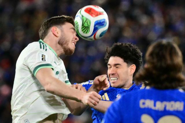 Northern Ireland's defender  #13 Ruairi McConville (L) fights for the ball with Italy's defender #21 Alessandro Bastoni during the play-off FIFA World Cup 2026 European qualification semi-final football match between Italy and North Ireland at the Gewiss stadium in Bergamo, on March 26, 2026. (Photo by Stefano RELLANDINI / AFP)