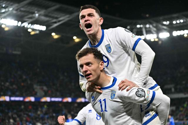 Kosovo's forward #11 Fisnik Asllani celebrates with a teammate after scoring the equalising goal during the play-off 2026 FIFA World Cup European qualification semi-final football match between Slovakia and Kosovo in Bratislava on March 26, 2026. (Photo by Joe Klamar / AFP)