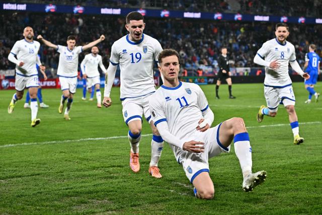 Kosovo's forward #11 Fisnik Asllani celebrates with teammates after scoring the equalising goal during the play-off 2026 FIFA World Cup European qualification semi-final football match between Slovakia and Kosovo in Bratislava on March 26, 2026. (Photo by Joe Klamar / AFP)
