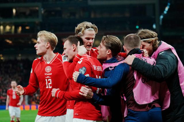 Denmark's forward #14 Mikkel Damsgaard (2L) celebrates scoring his team's first goal with team mates during the FIFA World Cup 2026 European qualification semi-final football match between Denmark and North Macedonia in Copenhagen on March 26, 2026. (Photo by Liselotte Sabroe / Ritzau Scanpix / AFP) / Denmark OUT