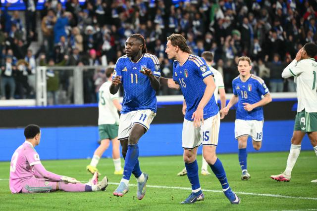 Italy's forward #11 Moise Kean (L) celebrates with teammate Italy's forward #15 Francesco Pio Esposito after scoring his team's second goal during the play-off FIFA World Cup 2026 European qualification semi-final football match between Italy and North Ireland at the Gewiss stadium in Bergamo, on March 26, 2026. (Photo by Alberto PIZZOLI / AFP)