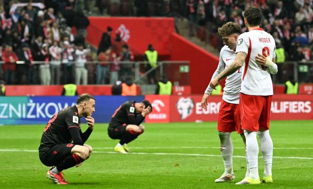 Poland's forward #21 Oskar Pietuszewski (R) and Poland's midfielder #08 Jakub Moder celebrate next to Albania's players at the end of the play-off FIFA World Cup 2026 European qualification semi-final football match between Poland and Albania in Warsaw on March 26, 2026. Poland won the match 2-1. (Photo by Sergei GAPON / AFP)