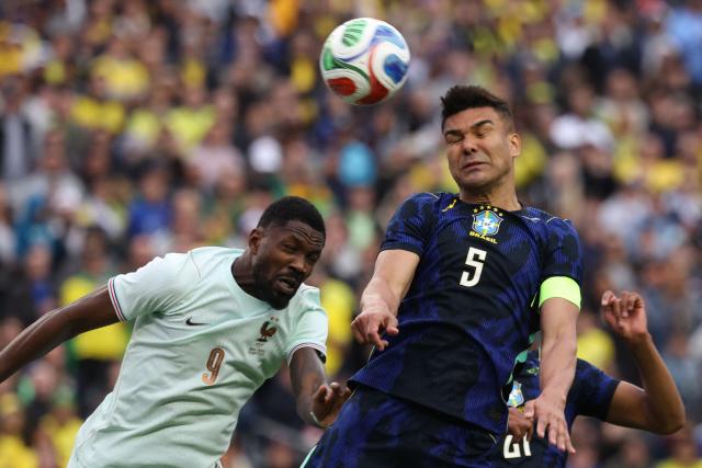 Brazil's midfielder #05 Casemiro heads the ball against French forward #09 Marcus Thuram during a friendly football match between Brazil and France at Gillette Stadium in Foxborough, Massachusetts, on March 26, 2026. (Photo by FRANCK FIFE / AFP)