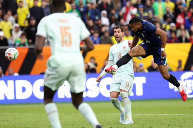 Brazil's defender #14 Bremer shoots past France's defender #19 Theo Hernandez during a friendly football match between Brazil and France at Gillette Stadium in Foxborough, Massachusetts, on March 26, 2026. (Photo by FRANCK FIFE / AFP)