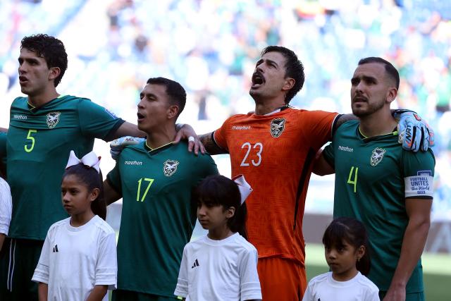 (L to R) Bolivia's defender #05 Efrain Morales, midfielder #17 Roberto Fernandez, goalkeeper #23 Guillermo Viscarra and defender #04 Luis Haquin sing the national anthem ahead of the 2026 FIFA World Cup qualifiers semi-final playoff football match between Bolivia and Suriname at the BBVA Stadium in Guadalupe, Mexico on March 26, 2026. (Photo by Julio Cesar AGUILAR / AFP)