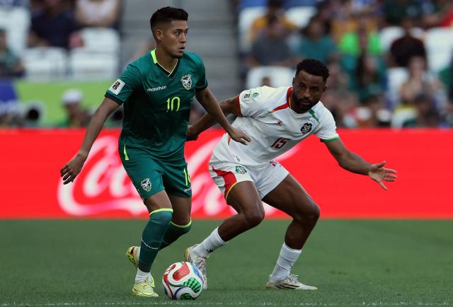 Bolivia's forward #10 Ramiro Vaca and Suriname's defender #15 Djavan Anderson fight for the ball during the 2026 FIFA World Cup qualifiers semi-final playoff football match between Bolivia and Suriname at the BBVA Stadium in Guadalupe, Mexico on March 26, 2026. (Photo by Julio Cesar AGUILAR / AFP)