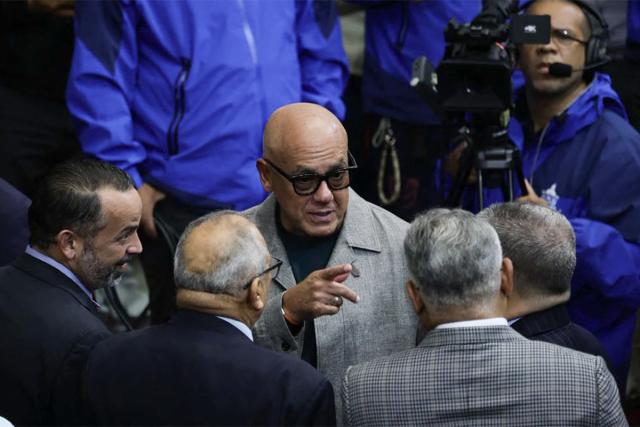 Venezuela's National Assembly President Jorge Rodriguez (C) talks with deputies before a session at the National Assembly in Caracas on March 26, 2026. (Photo by Jesus VARGAS / AFP)