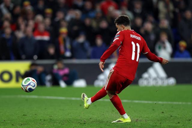 Wales' midfielder Brennan Johnson shoots from the penalty spot but fails to score during the FIFA World Cup qualification semi-final football match between Wales and Bosnia and Herzegovina, at Cardiff City Stadium, in Cardiff, on March 26, 2026. (Photo by Darren Staples / AFP)