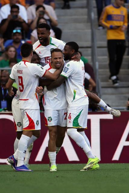 Suriname's defender #20 Liam van Gelderen (C) celebrates with teammates forward #09 Joel Piroe (L), defender #15 Djavan Anderson (C, back) and defender #04 Stefano Denswil after scoring his team's first goal during the 2026 FIFA World Cup qualifiers semi-final playoff football match between Bolivia and Suriname at the BBVA Stadium in Guadalupe, Mexico on March 26, 2026. (Photo by Julio Cesar AGUILAR / AFP)