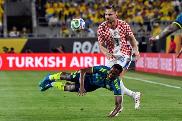 Croatia's defender #3 Marin Pongracic fights for the ball with Colombia's midfielder #11 Jhon Arias during a friendly football match between Colombia and Croatia at Camping World Stadium in Orlando, Florida, on March 26, 2026. (Photo by Miguel J. Rodriguez CARRILLO / AFP)