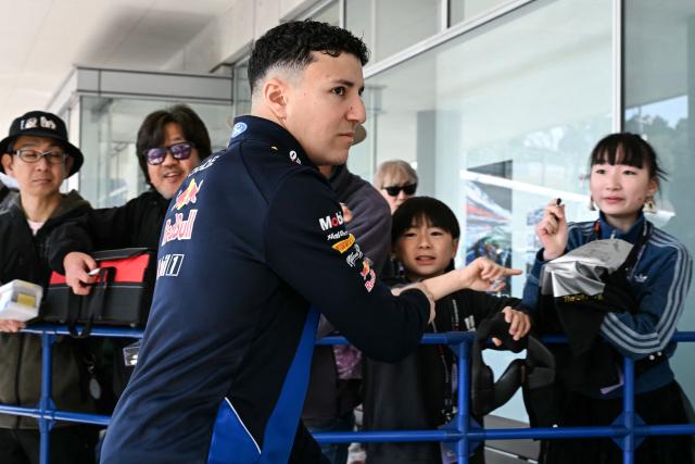 Red Bull Racing's French driver Isack Hadjar interacts with fans before the first practice session of the Formula One Japanese Grand Prix in Suzuka on March 27, 2026. (Photo by Toshifumi KITAMURA / AFP)