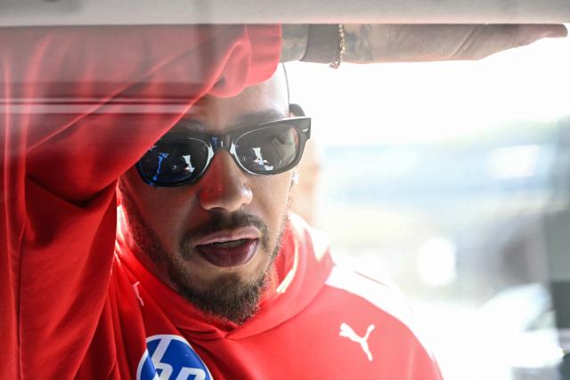 Ferrari's British driver Lewis Hamilton looks on before the first practice session of the Formula One Japanese Grand Prix in Suzuka on March 27, 2026. (Photo by Toshifumi KITAMURA / AFP)