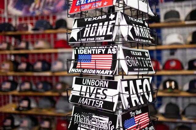 Conservative-themed stickers are displayed for sale at the Conservative Political Action Conference (CPAC) in Grapevine, Texas, on March 26, 2026. American conservatives converge on Texas this week for what organizers bill as their largest and most influential gathering, with the Iran war and fears of a punishing midterm election cycle heightening the stakes. (Photo by Leandro Lozada / AFP)