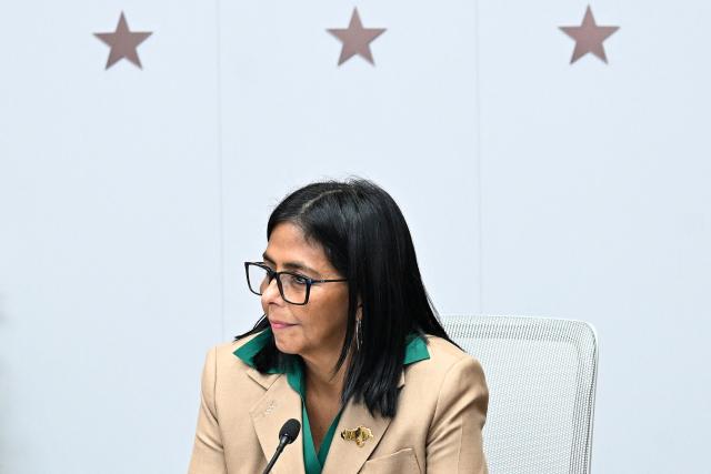 (FILES) Venezuela's interim President Delcy Rodriguez holds a meeting with the Colombian government delegation at the Miraflores Presidential Palace in Caracas on March 13, 2026. On March 26, 2026, Venezuelas interim president, Delcy Rodriguez, has declared a week-long holiday for the public sector amid high temperatures that have exacerbated the energy crisis in a country where power rationing is common. Venezuela has previously implemented shorter workdays and school closures to conserve energy in a country where power rationing has been a reality for years. (Photo by Juan BARRETO / AFP)