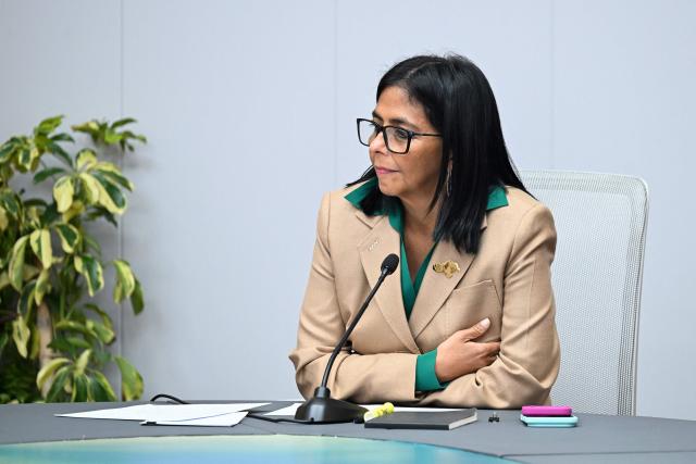 (FILES) Venezuela's interim President Delcy Rodriguez holds a meeting with the Colombian government delegation at the Miraflores Presidential Palace in Caracas on March 13, 2026. On March 26, 2026, Venezuelas interim president, Delcy Rodriguez, has declared a week-long holiday for the public sector amid high temperatures that have exacerbated the energy crisis in a country where power rationing is common. Venezuela has previously implemented shorter workdays and school closures to conserve energy in a country where power rationing has been a reality for years. (Photo by Juan BARRETO / AFP)