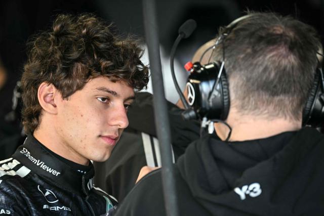 Mercedes' Italian driver Kimi Antonelli (L) speaks with a team member before the first practice session of the Formula One Japanese Grand Prix in Suzuka, Mie prefecture on March 27, 2026. (Photo by Philip FONG / AFP)