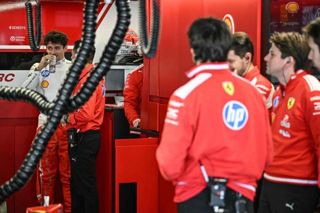 Ferrari's Monegasque driver Charles Leclerc (L) prepares before the first practice session of the Formula One Japanese Grand Prix in Suzuka, Mie prefecture on March 27, 2026. (Photo by Philip FONG / AFP)