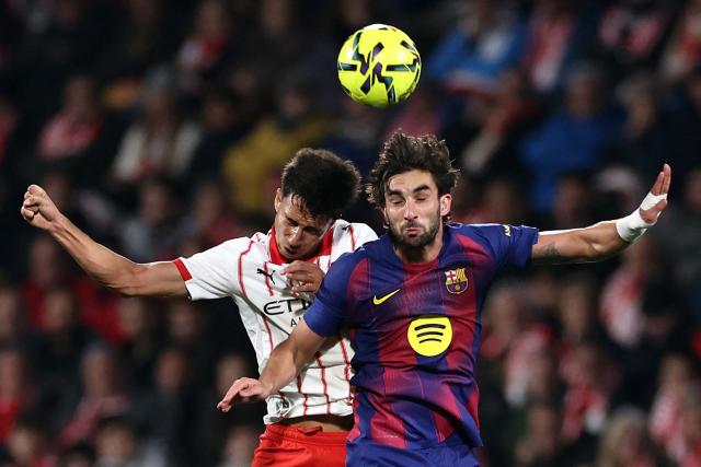 (FILES) Girona's Brazilian defender #12 Vitor Reis and Barcelona's Spanish forward #07 Ferran Torres fight for the ball during the Spanish league football match between Girona FC and FC Barcelona at Montilivi Stadium in Girona on February 16, 2026. Brazilian defender Vitor Reis, who plays for Girona in Spain, was called up by Brazil on March 26, 2026, for next March 31 friendly match against Croatia in Orlando, Florida, the Brazilian Football Confederation (CBF) announced. (Photo by Josep LAGO / AFP)