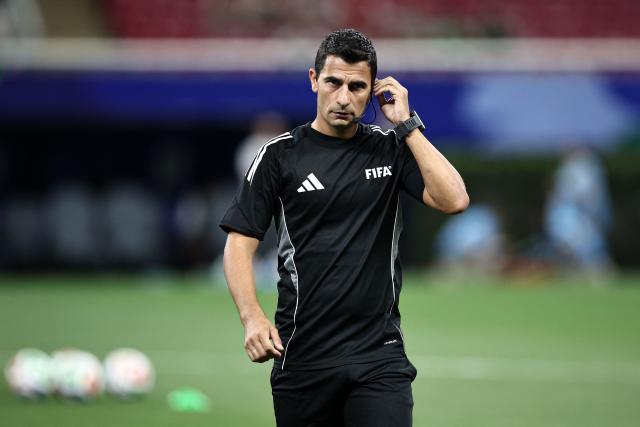 Uruguayan referee Gustavo Tejera adjusts his headset before the 2026 FIFA World Cup qualifiers semi-final playoff football match between New Caledonia and Jamaica at the Akron Stadium in Zapopan, state of Jalisco, Mexico on March 26, 2026. (Photo by Ulises Ruiz / AFP)