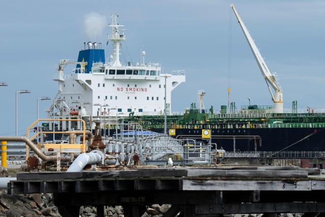 The tanker ship Oak Express unloads oil at the Seaview fuel terminal at Point Howard in Wellington on March 27, 2026. (Photo by Marty MELVILLE / AFP)