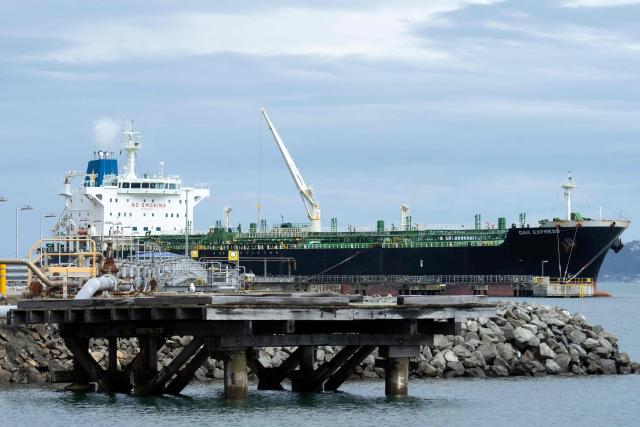 The tanker ship Oak Express unloads oil at the Seaview fuel terminal at Point Howard in Wellington on March 27, 2026. (Photo by Marty MELVILLE / AFP)