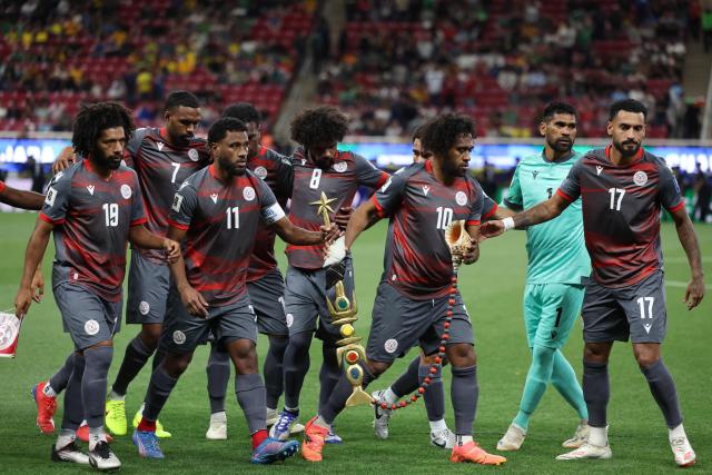 Players of New Caledonia grab an amulet before posing for a picture ahead of the 2026 FIFA World Cup qualifiers semi-final playoff football match between New Caledonia and Jamaica at the Akron Stadium in Zapopan, Mexico on March 26, 2026. (Photo by Ulises Ruiz / AFP)