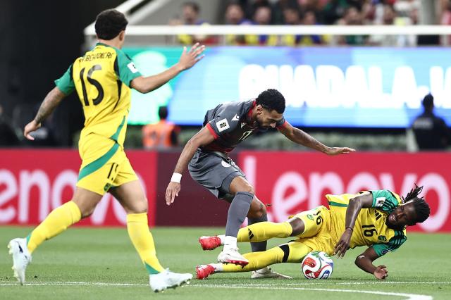 New Caledonia's midfielder #17 Angelo Fulgini and Jamaica's midfielder #16 Karoy Anderson fight for the ball during the 2026 FIFA World Cup qualifiers semi-final playoff football match between New Caledonia and Jamaica at the Akron Stadium in Zapopan, Mexico on March 26, 2026. (Photo by Ulises Ruiz / AFP)