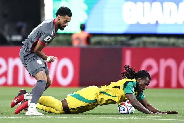 New Caledonia's midfielder #17 Angelo Fulgini and Jamaica's midfielder #16 Karoy Anderson fight for the ball during the 2026 FIFA World Cup qualifiers semi-final playoff football match between New Caledonia and Jamaica at the Akron Stadium in Zapopan, Mexico on March 26, 2026. (Photo by Ulises Ruiz / AFP)