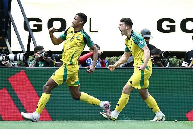 Jamaica's forward #09 Bailey Cadamarteri (R) celebrates with teammate defender #06 Richard King after scoring the opening goal during the 2026 FIFA World Cup qualifiers semi-final playoff football match between New Caledonia and Jamaica at the Akron Stadium in Zapopan, Mexico on March 26, 2026. (Photo by Ulises Ruiz / AFP)