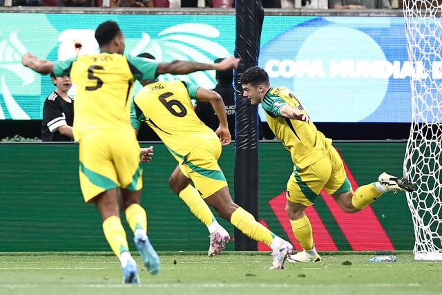 Jamaica's forward #09 Bailey Cadamarteri (R) celebrates with teammates defender #06 Richard King and midfielder #05 Ethan Pinnock after scoring the opening goal during the 2026 FIFA World Cup qualifiers semi-final playoff football match between New Caledonia and Jamaica at the Akron Stadium in Zapopan, Mexico on March 26, 2026. (Photo by Ulises Ruiz / AFP)