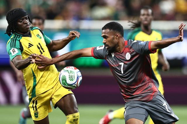Jamaica's forward #11 Tyreece Campbell and New Caledonia's midfielder #07 Jekob Jeno fight for the ball during the 2026 FIFA World Cup qualifiers semi-final playoff football match between New Caledonia and Jamaica at the Akron Stadium in Zapopan, Mexico on March 26, 2026. (Photo by Ulises Ruiz / AFP)