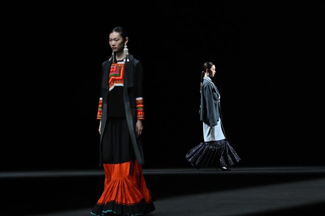 Models present creations by Yan Liang during the China Fashion Week in Beijing on March 26, 2026. (Photo by Pedro PARDO / AFP)
