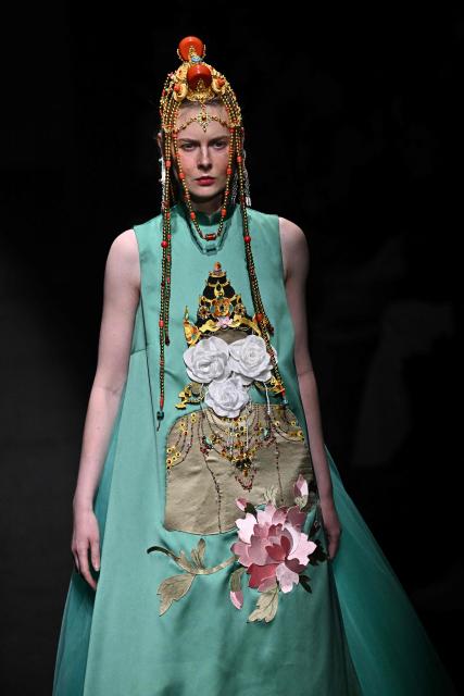 A model presents a creation by GRZG Rongrong Guo during the China Fashion Week in Beijing on March 26, 2026. (Photo by Pedro PARDO / AFP)