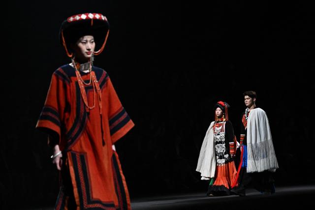 Models present creations by Yan Liang during the China Fashion Week in Beijing on March 26, 2026. (Photo by Pedro PARDO / AFP)