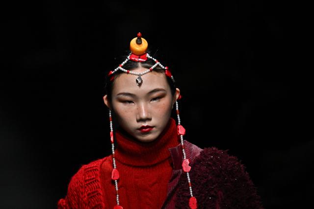 A model presents a creation by GRZG Rongrong Guo during the China Fashion Week in Beijing on March 26, 2026. (Photo by Pedro PARDO / AFP)