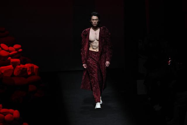 A model presents a creation by GRZG Rongrong Guo during the China Fashion Week in Beijing on March 26, 2026. (Photo by Pedro PARDO / AFP)